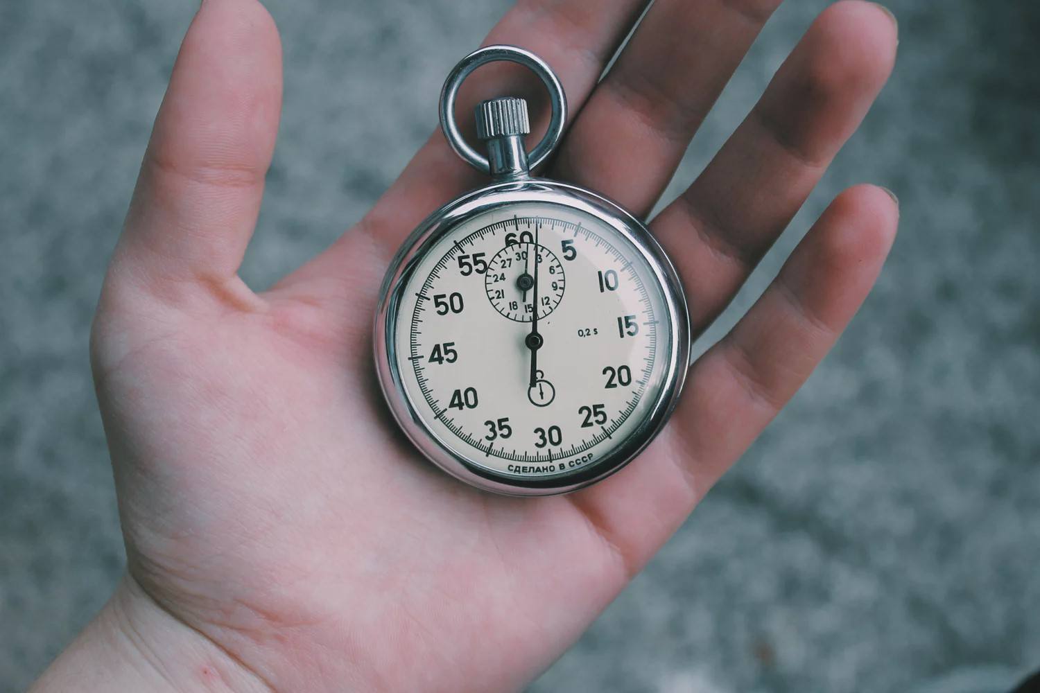 A stopwatch in someone's hand.