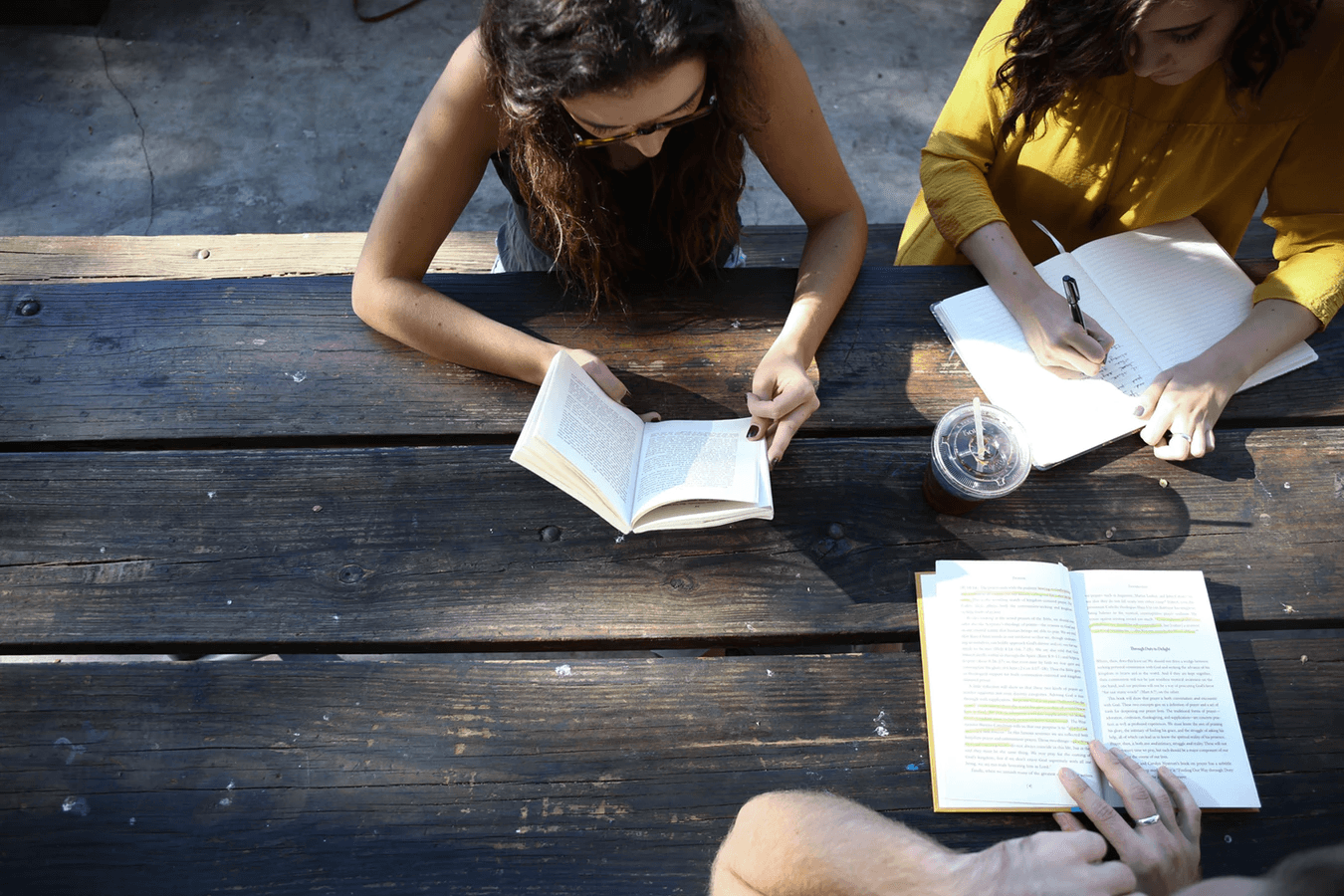 A group of people reading and taking notes.